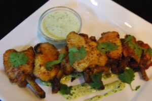 French Cut Joyce Farms Chicken Wings with Dry Rubbed Spanish Curry served with Cilantro Dipping Sauce